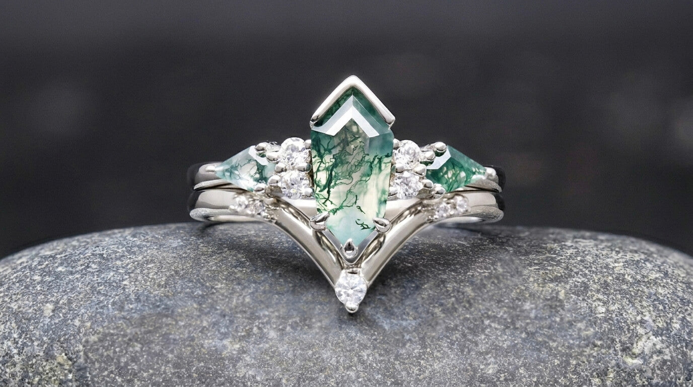 Moss agate engagement ring with natural green patterns on a dark background