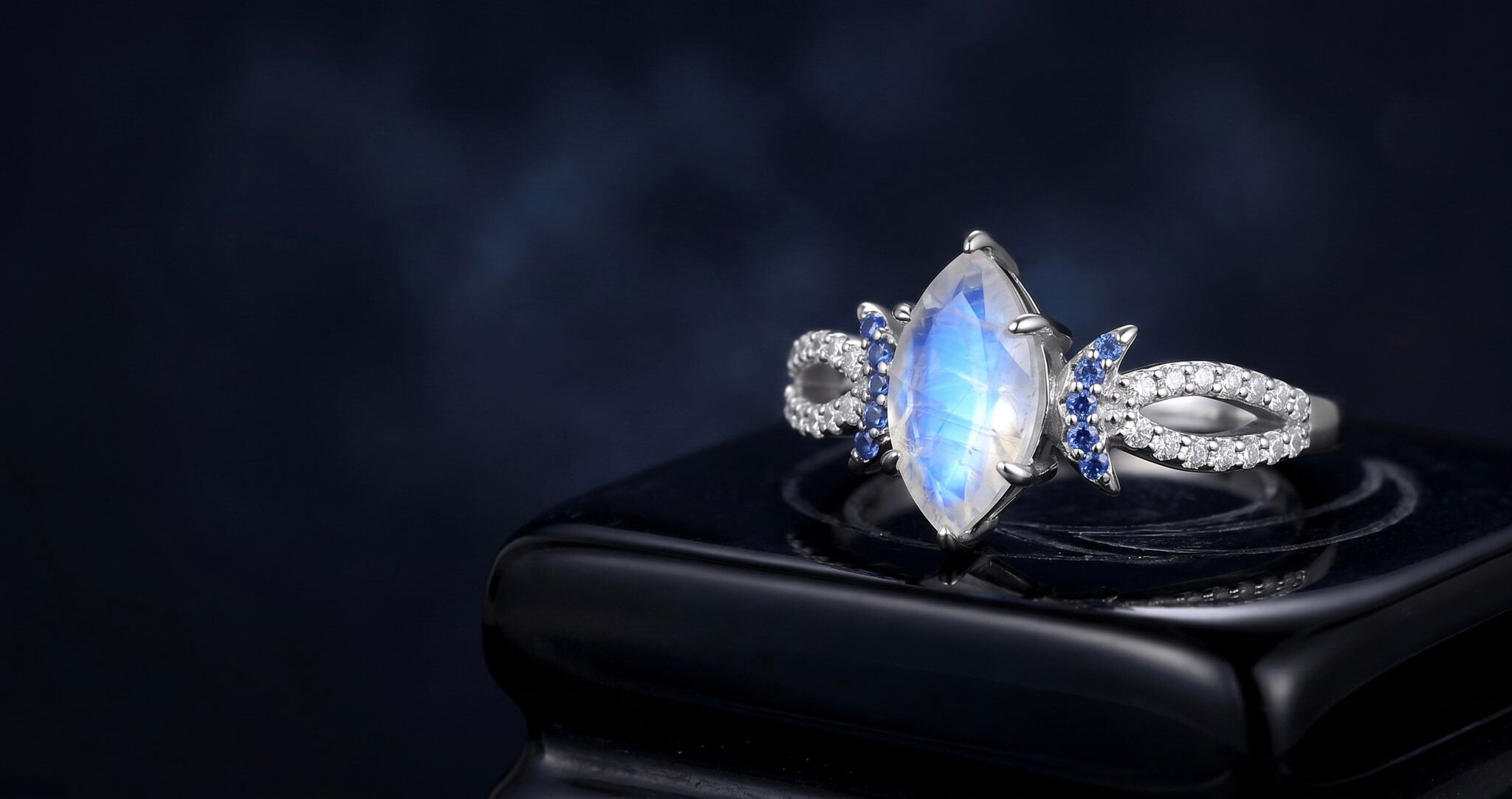 Fantasy engagement ring with blue sandstone center and ornate silver setting