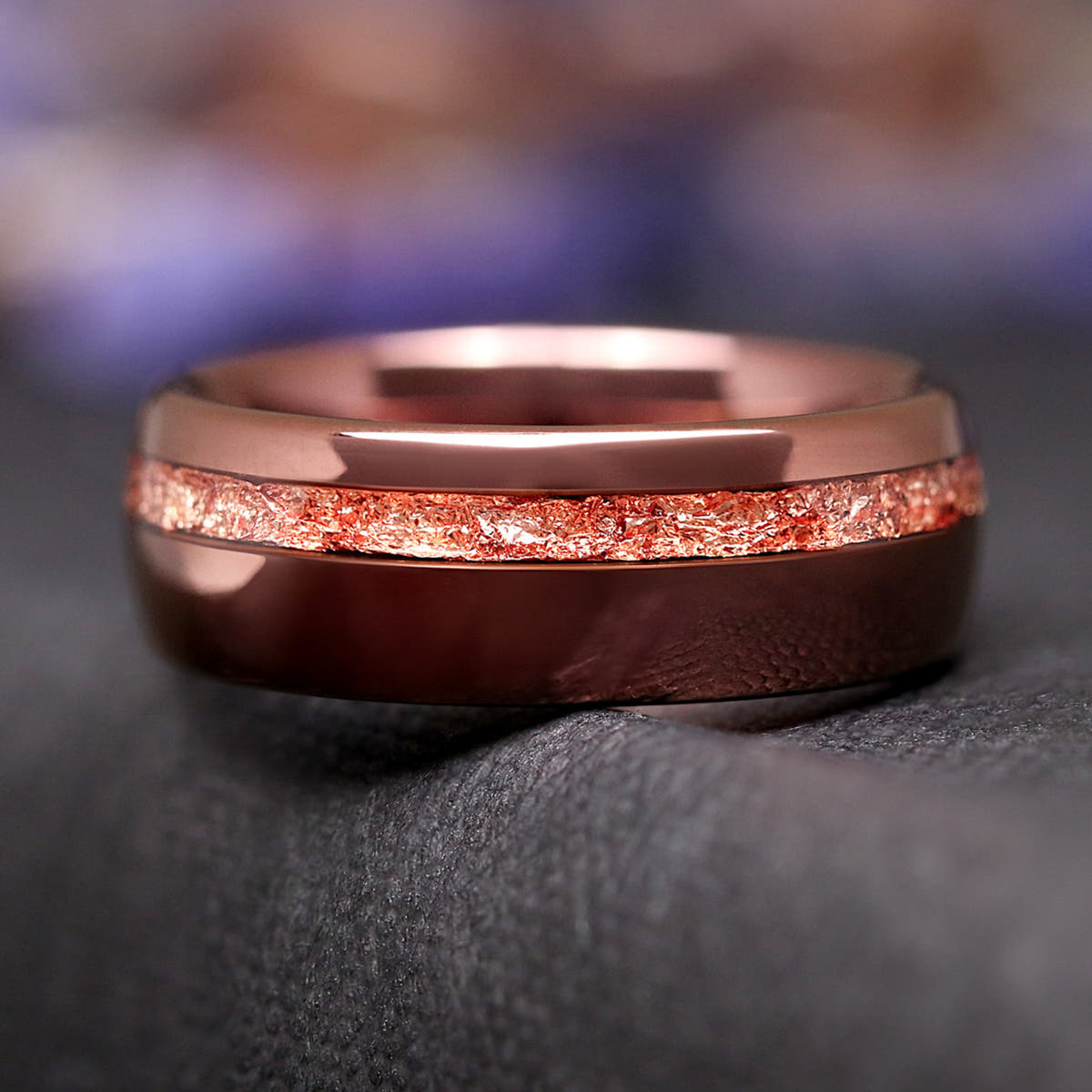 Espresso tungsten wedding band shown straight on, rose gold foil stripe near the edge