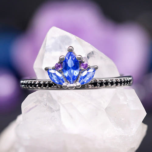 Blue lotus engagement ring in sterling silver with marquise sapphire petals and amethyst accents, close crop