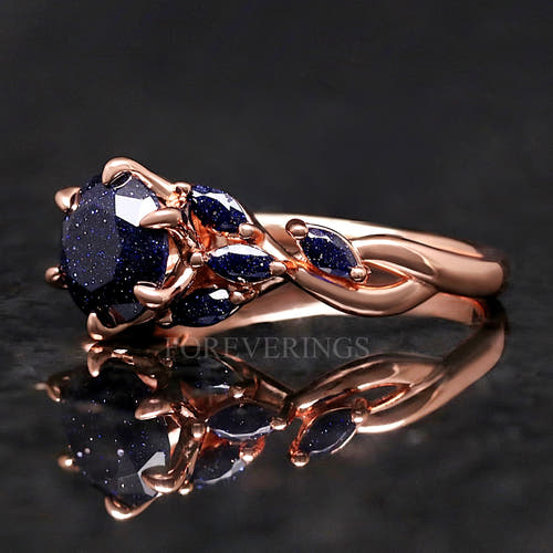 Women's rose gold sterling silver oval blue sandstone ring with leaf accents, close angled view