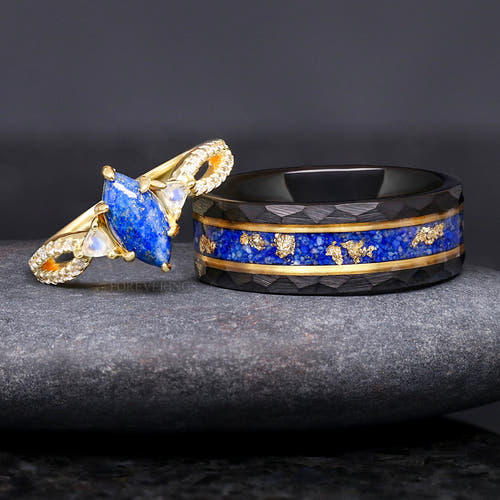 Gold lapis lazuli engagement ring beside a hammered black tungsten band with lapis and gold leaf inlay