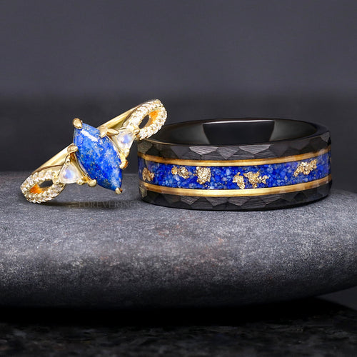 Gold lapis lazuli engagement ring beside a hammered black tungsten band with lapis and gold leaf inlay
