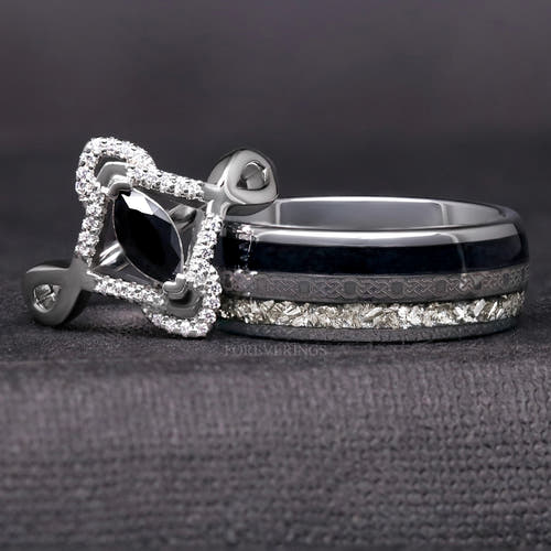 Sterling silver marquise black stone ring with a white stone halo beside a wide silver tungsten band