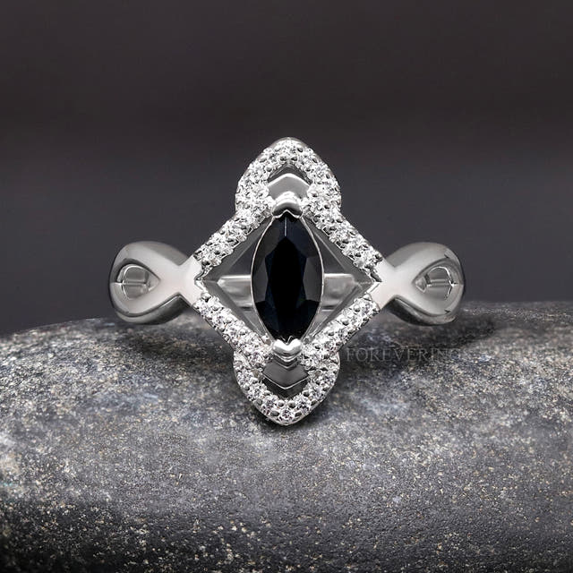 Women's sterling silver marquise black stone ring with a halo of white stones, straight on