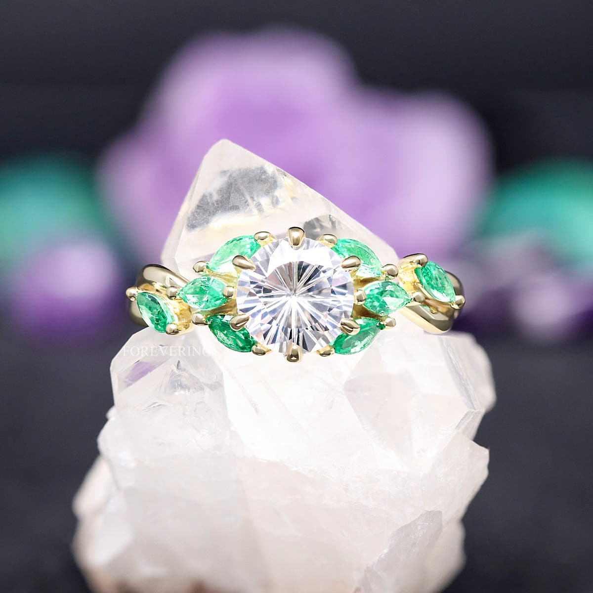 Women's gold sterling silver white sapphire engagement ring with emerald leaf accents, straight on