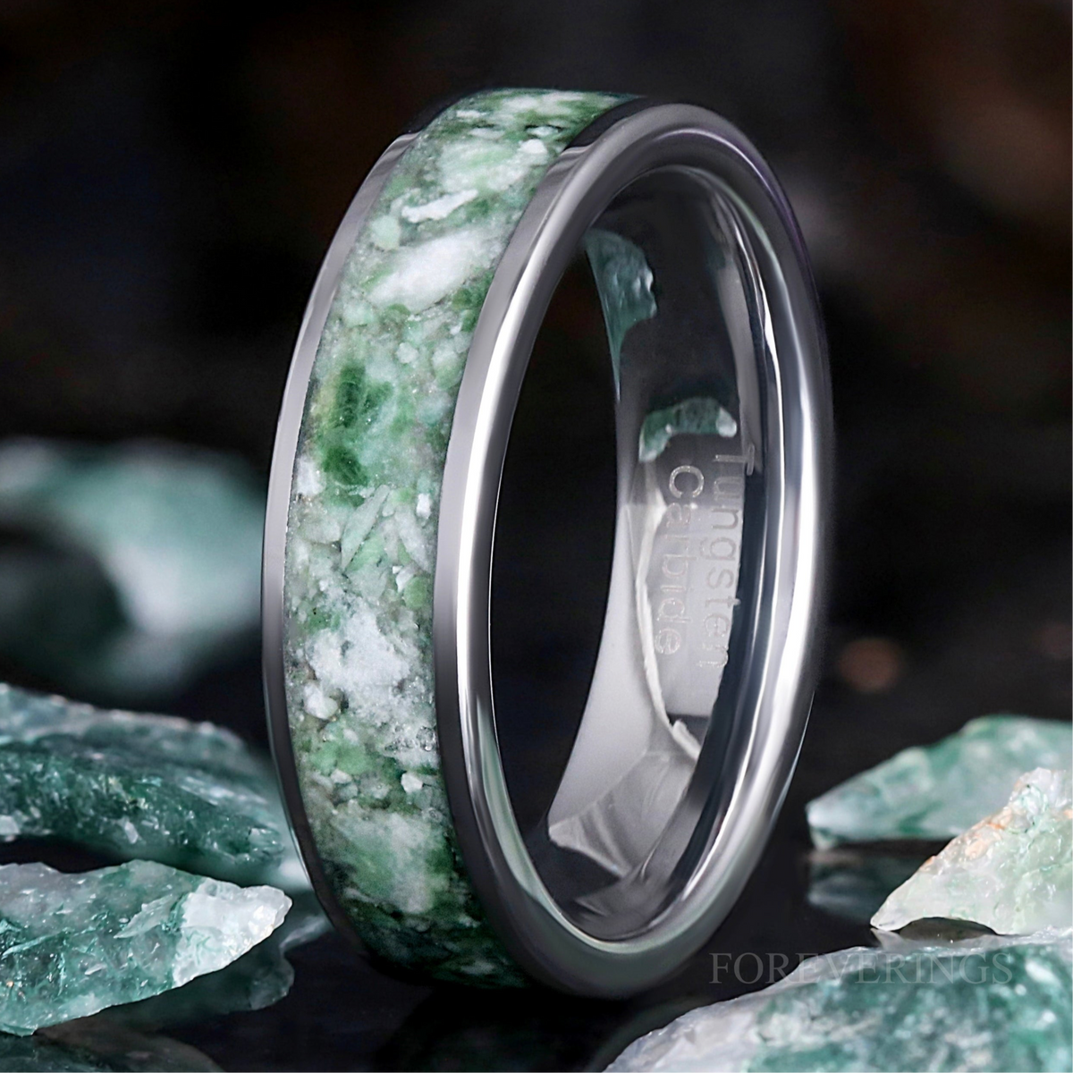 Men's 6mm silver tungsten wedding band with natural green moss agate inlay, standing on edge