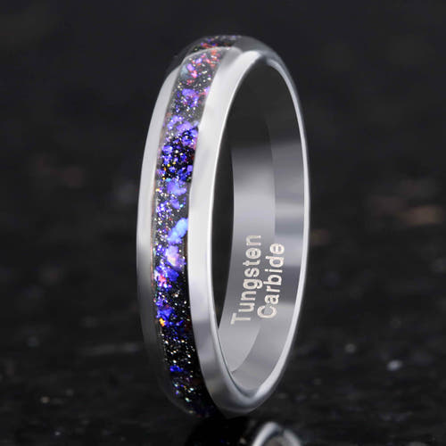 Tungsten carbide ring with colorful inlay on a dark background