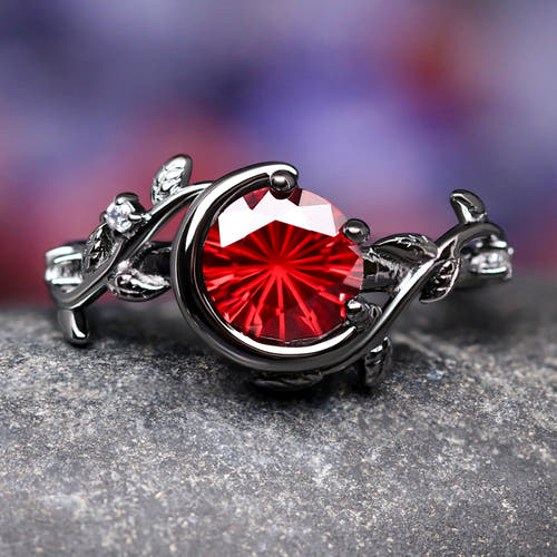 Women's black sterling silver crescent moon ring with a round rhodolite, shown straight on