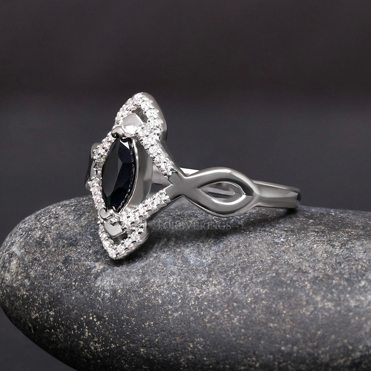 Marquise black stone ring in sterling silver, angled side view showing the twisted band