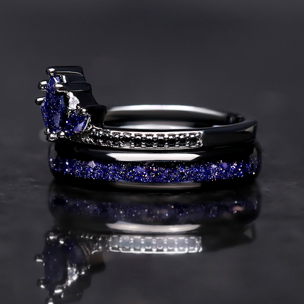 Black lotus ring with blue sandstone stacked on a black tungsten sandstone band, side view