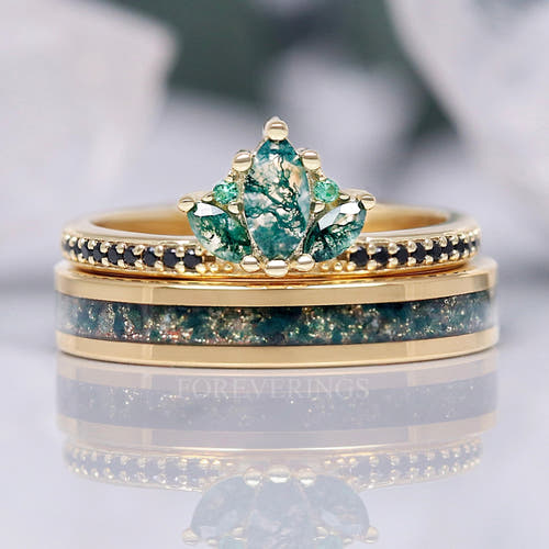 Women's gold lotus crown engagement ring with marquise moss agate, stacked on a moss agate inlay band