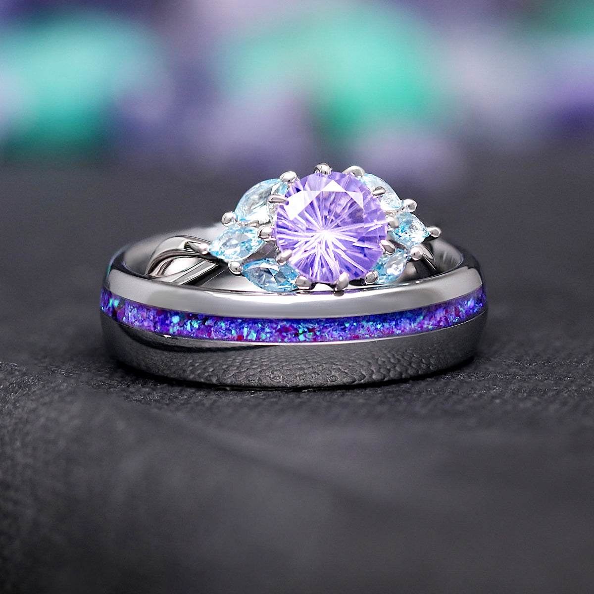 His and hers wedding ring set in silver: amethyst ring resting behind the opal inlay band