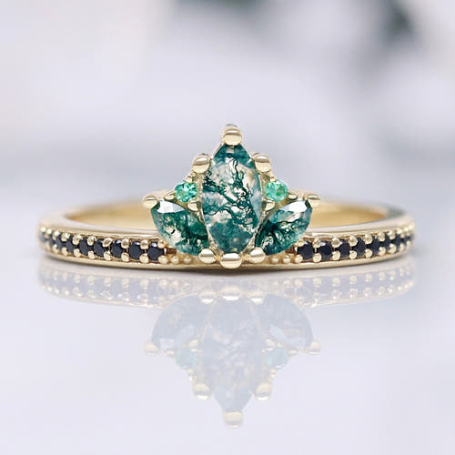 Women's gold sterling silver moss agate lotus ring with black accent stones, shown straight on