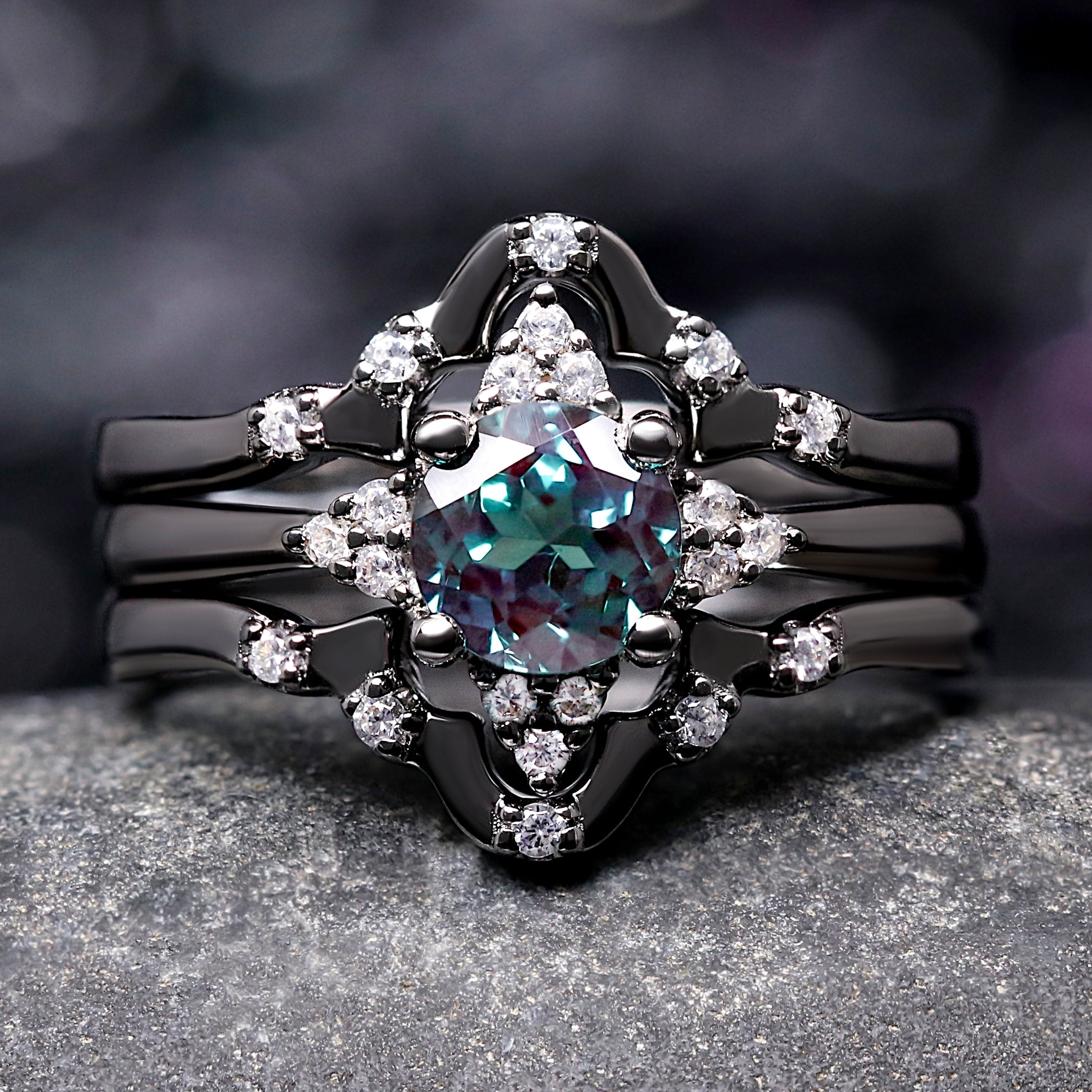 Black ring with a central gemstone and diamond accents on a dark background