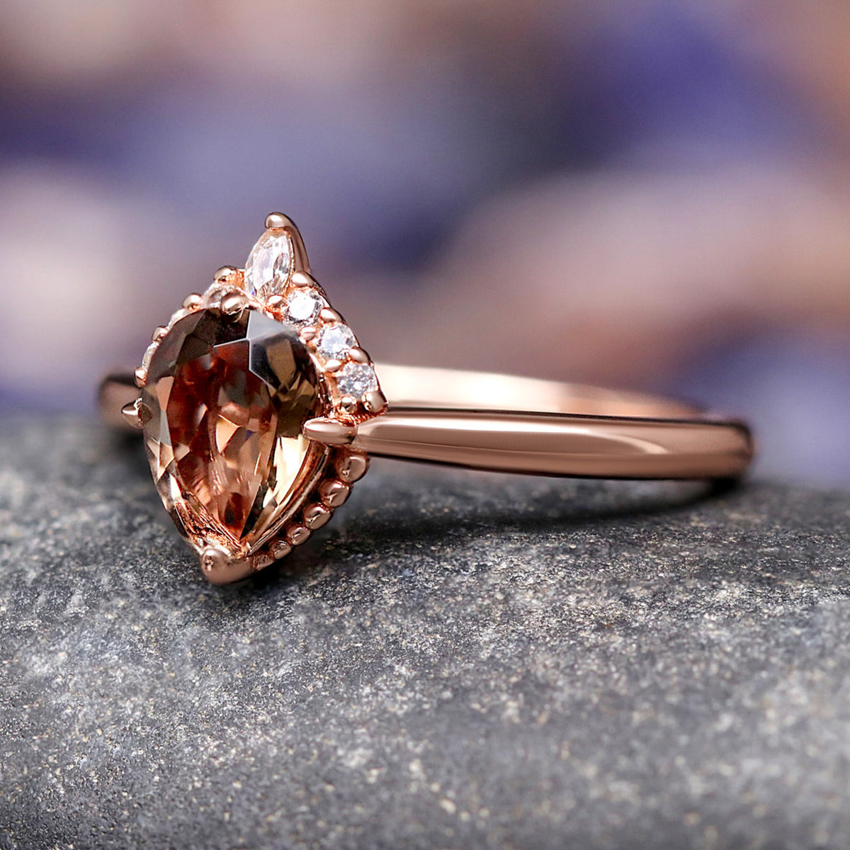 Rose gold smoky quartz engagement ring at an angle, pear stone and thin band