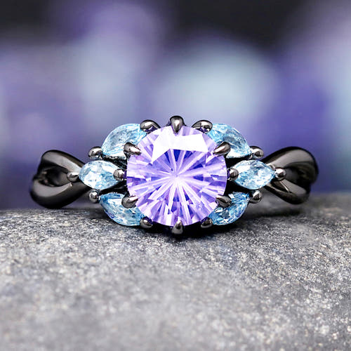 Black ring with a purple amethyst and blue aquamarine.