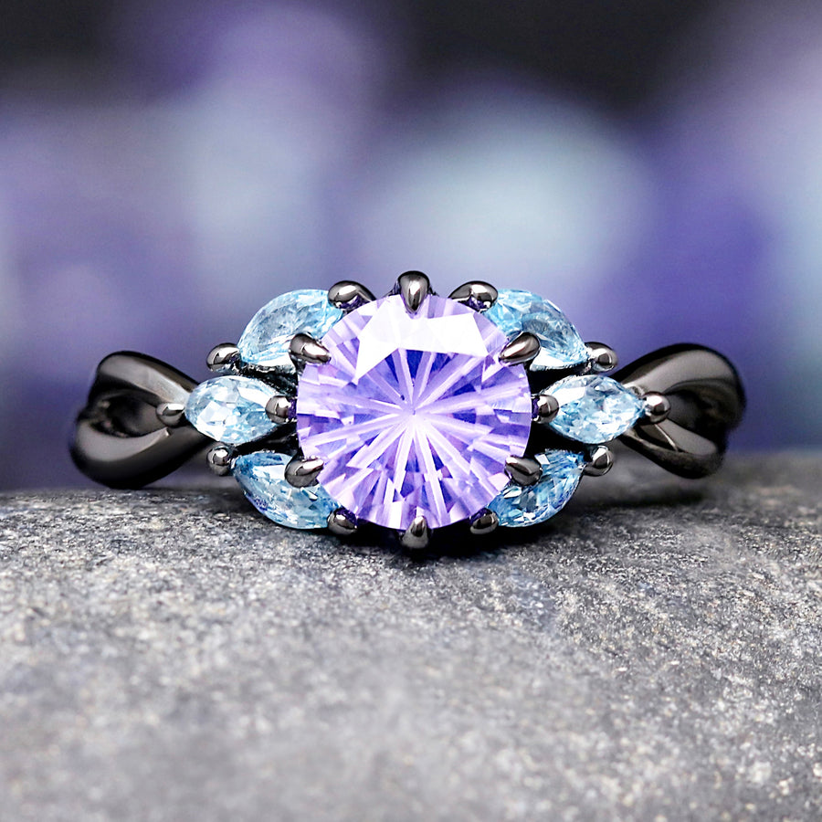 Black ring with a purple amethyst and blue aquamarine.