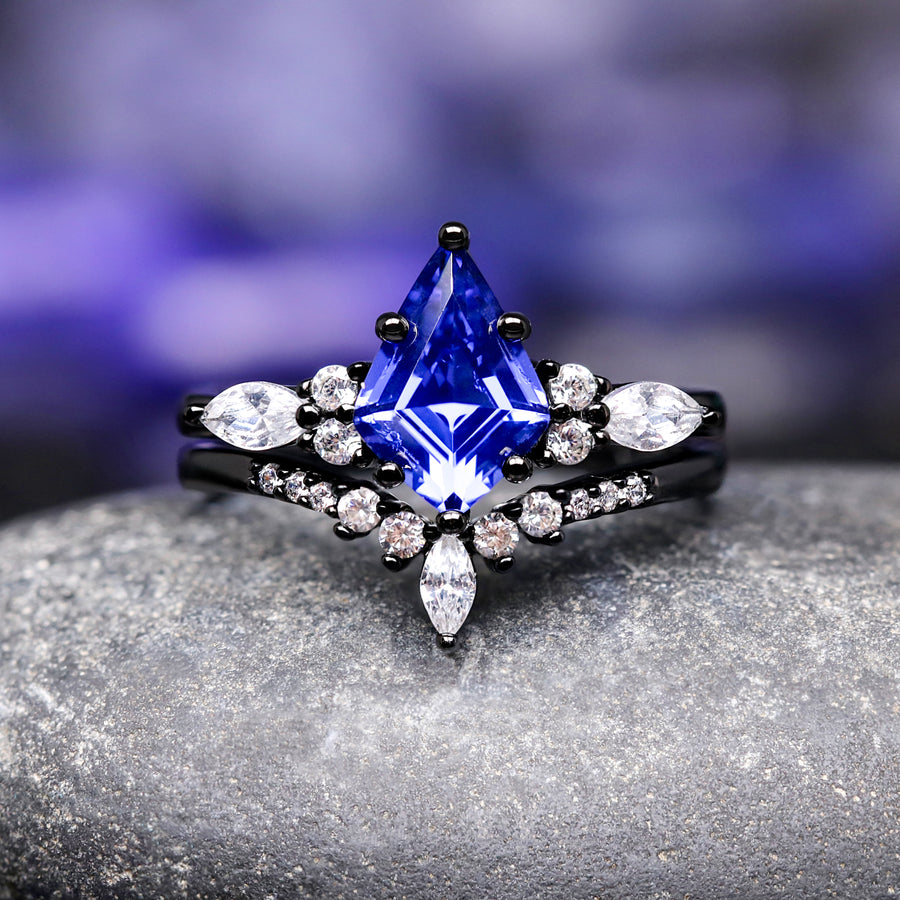 Blue gemstone ring with black band and diamonds