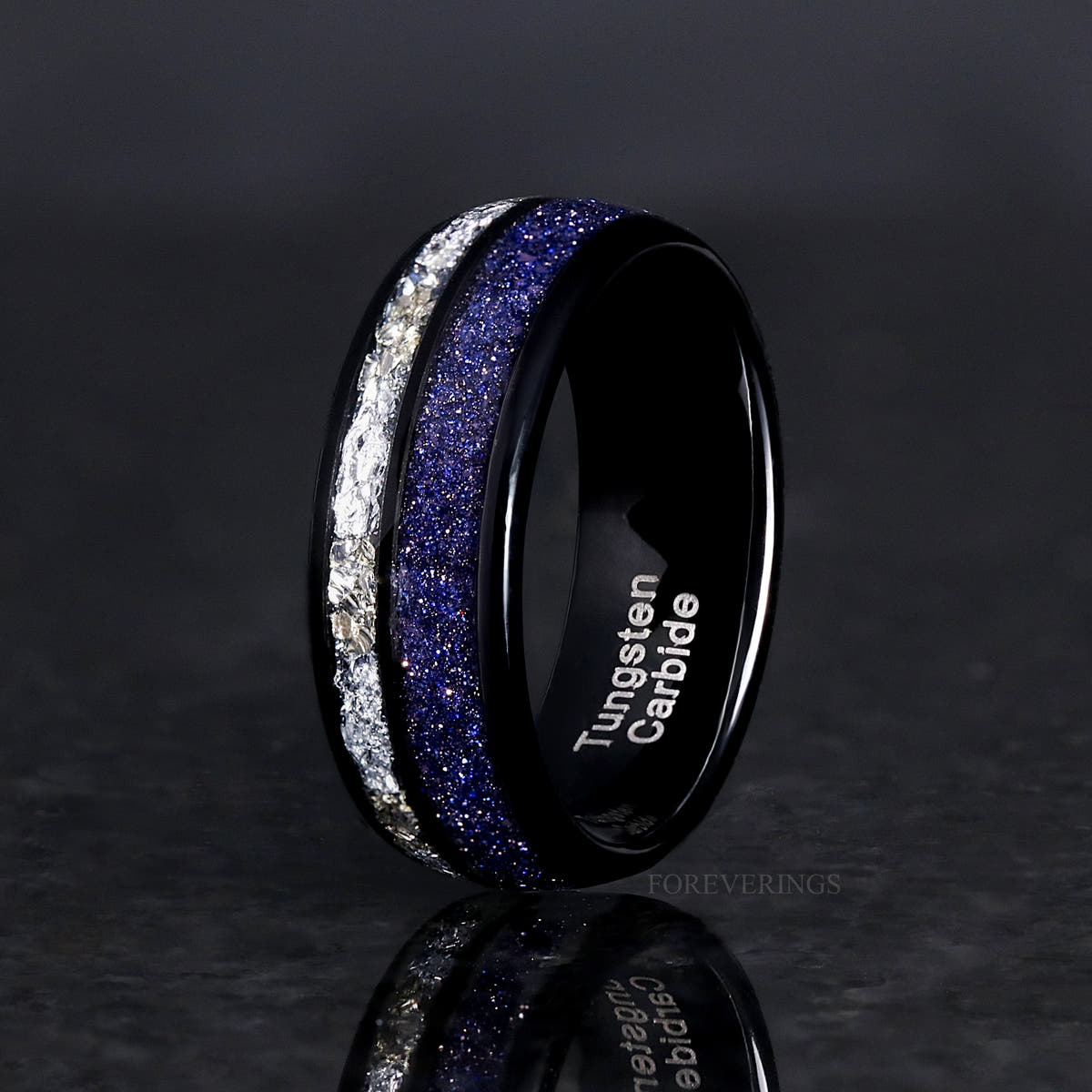 Men's 8mm black tungsten band with blue sandstone and crushed diamond stripes, standing at an angle