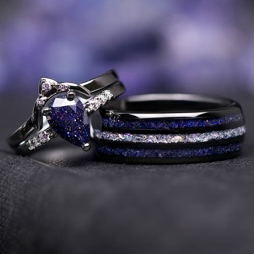 Matching black couples ring set: pear-cut blue sandstone engagement ring beside an 8mm moonstone inlay ring