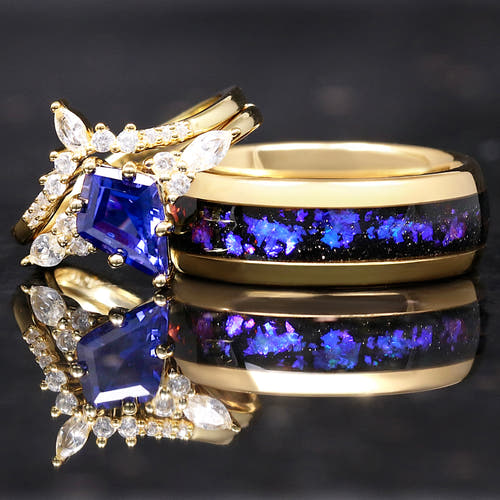 Matching gold couples ring set with kite-cut sapphire engagement ring and Orion nebula inlay band