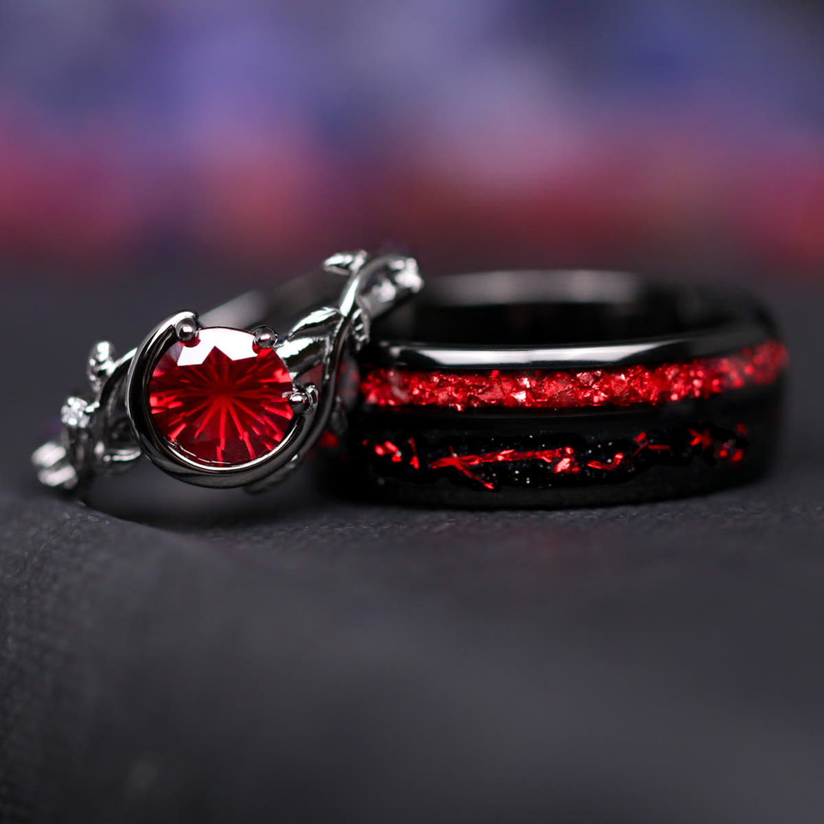 Matching black couples ring set: crescent moon rhodolite ring leaning on an 8mm tungsten band with ruby inlay