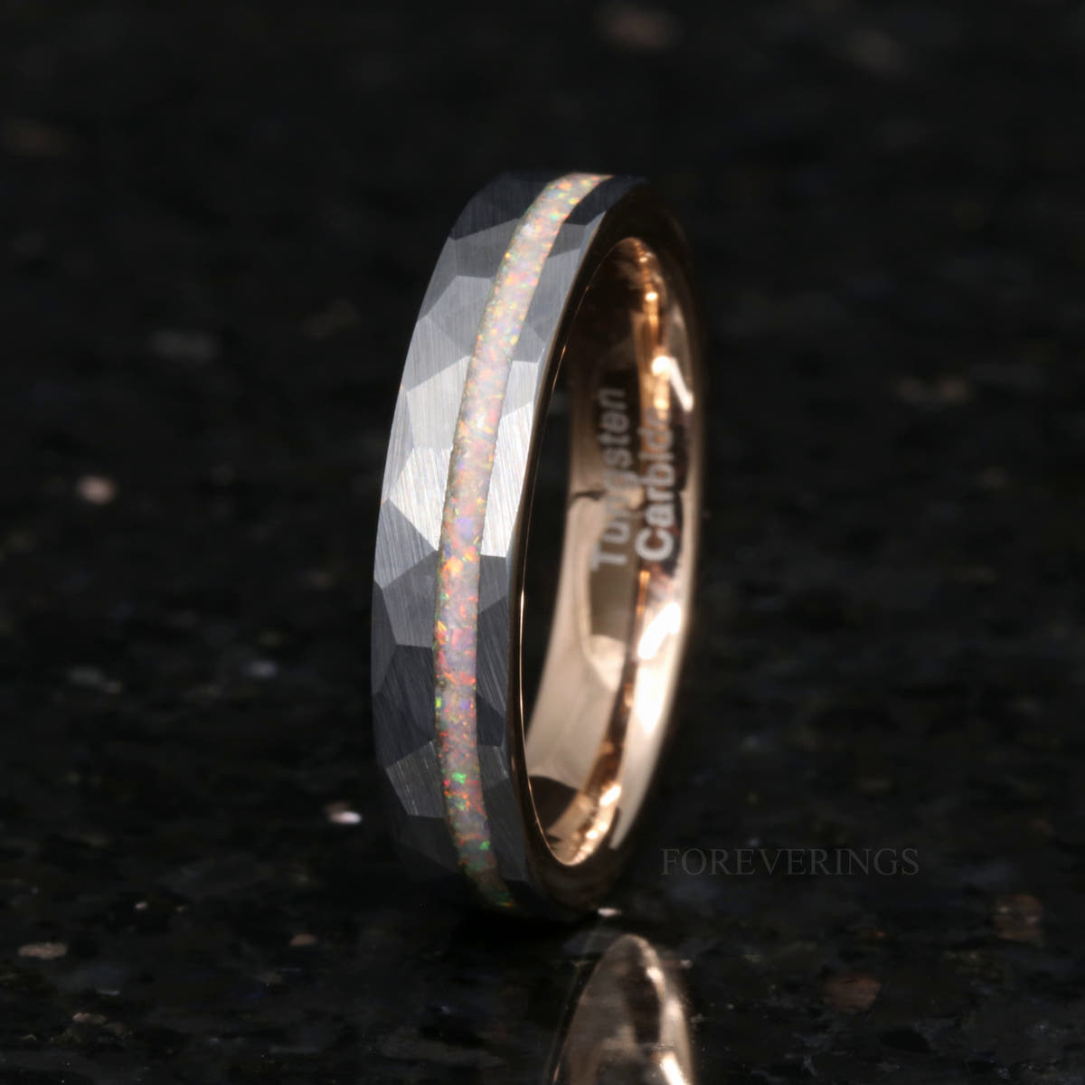 Women's 4mm hammered silver tungsten ring with white fire opal inlay, rose gold inside, standing on edge
