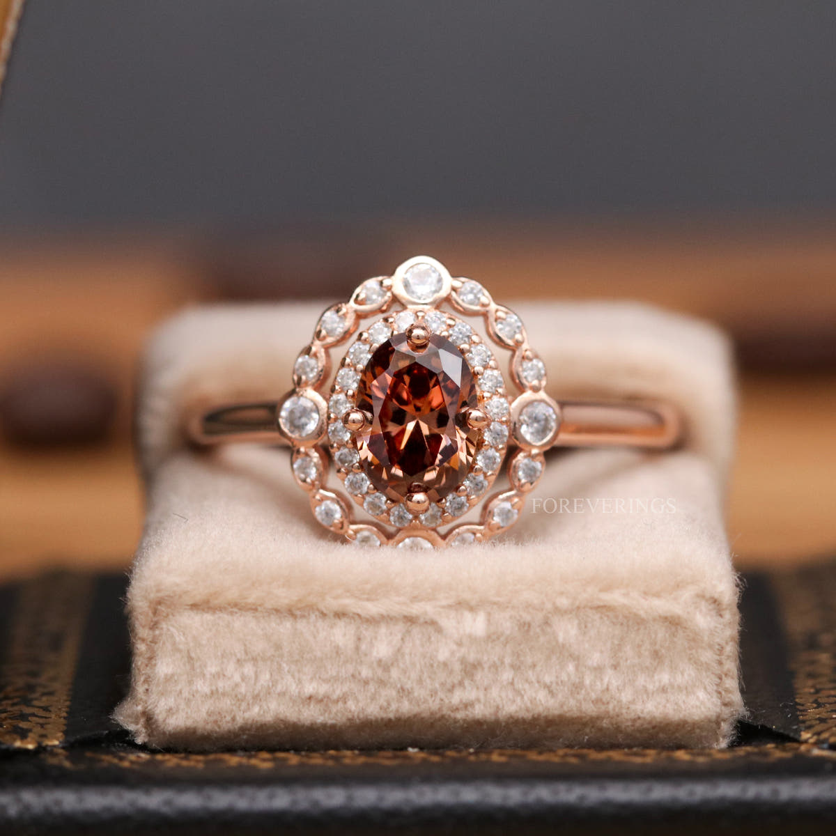 Rose gold oval smoky quartz engagement ring sitting in a ring box, wider view