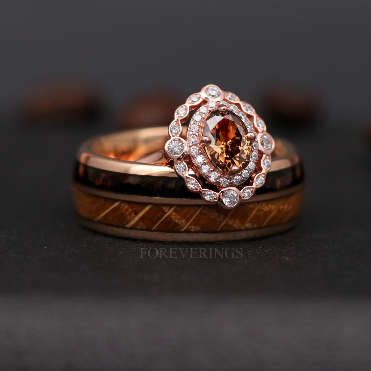 Smoky quartz halo engagement ring resting on a wider rose gold band with wood inlay