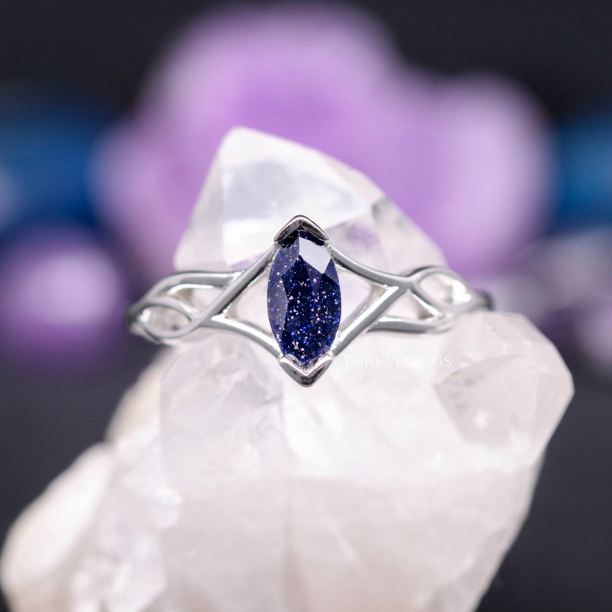 Women's sterling silver marquise blue sandstone ring with an open twisted band, shown straight on