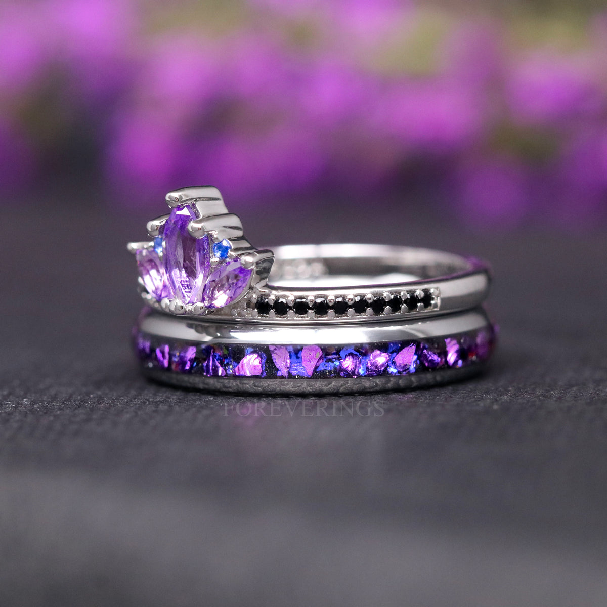 Side view of the amethyst lotus ring stacked on the band, blue side stones and black accents
