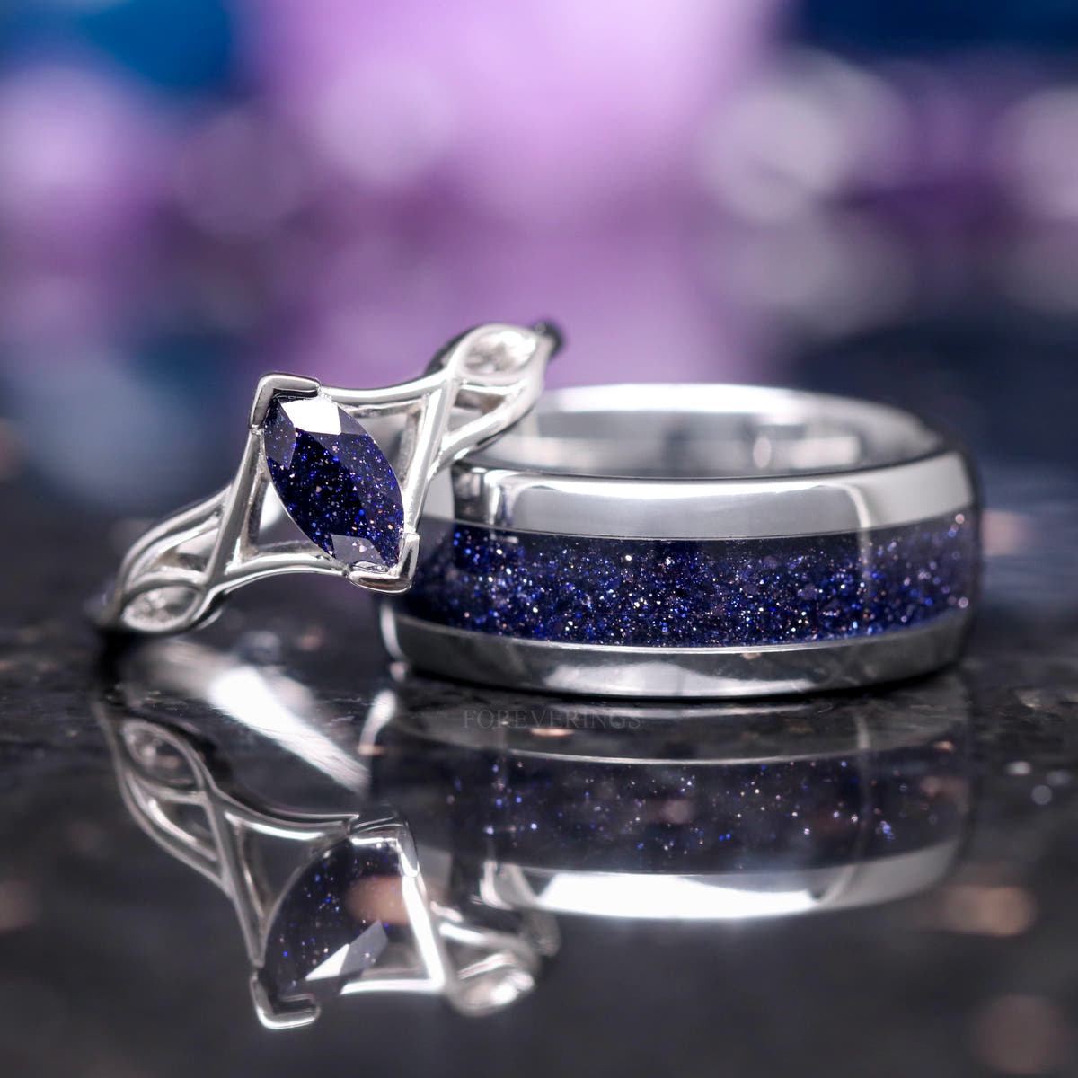 Marquise blue sandstone ring beside a wider silver band with blue sandstone inlay