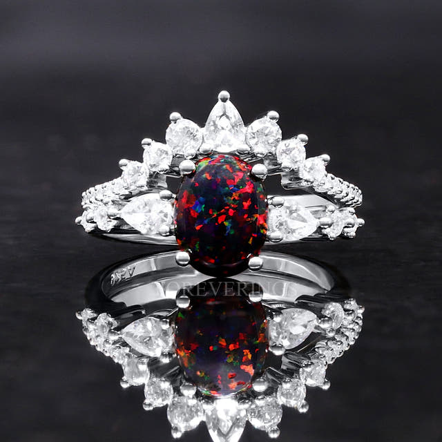 Women's sterling silver bridal set with an oval black fire opal and a crown of clear stones, front view