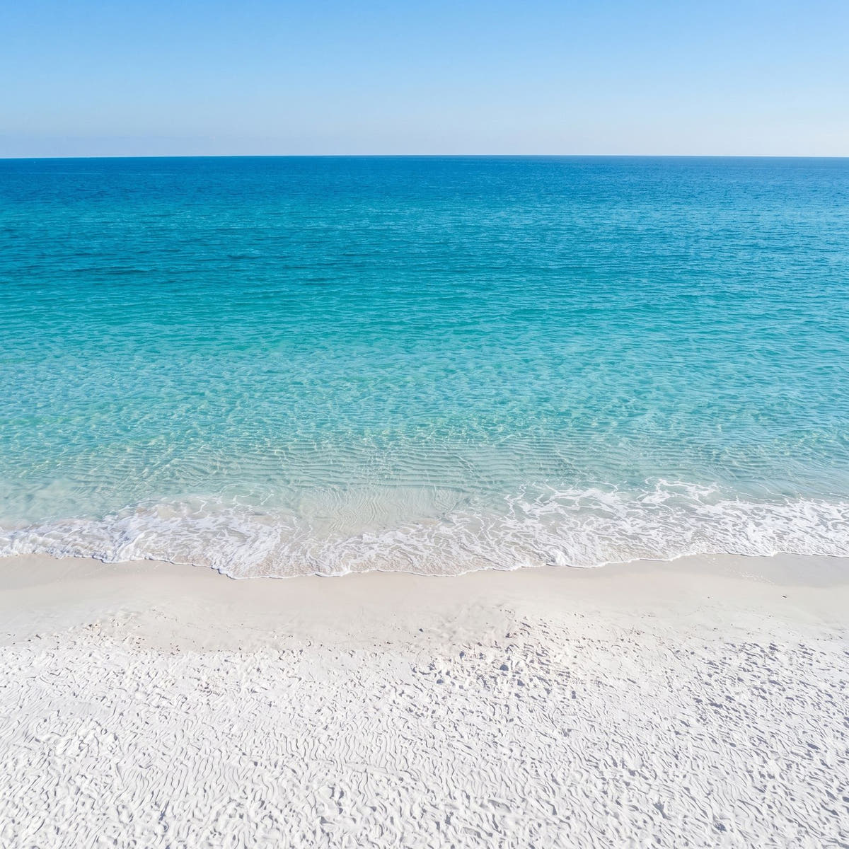 White sand beach and turquoise Emerald Coast water, the inspiration for the Emerald Coast opal ring