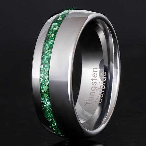Men's silver tungsten wedding band with crushed emerald inlay, polished dome, close crop