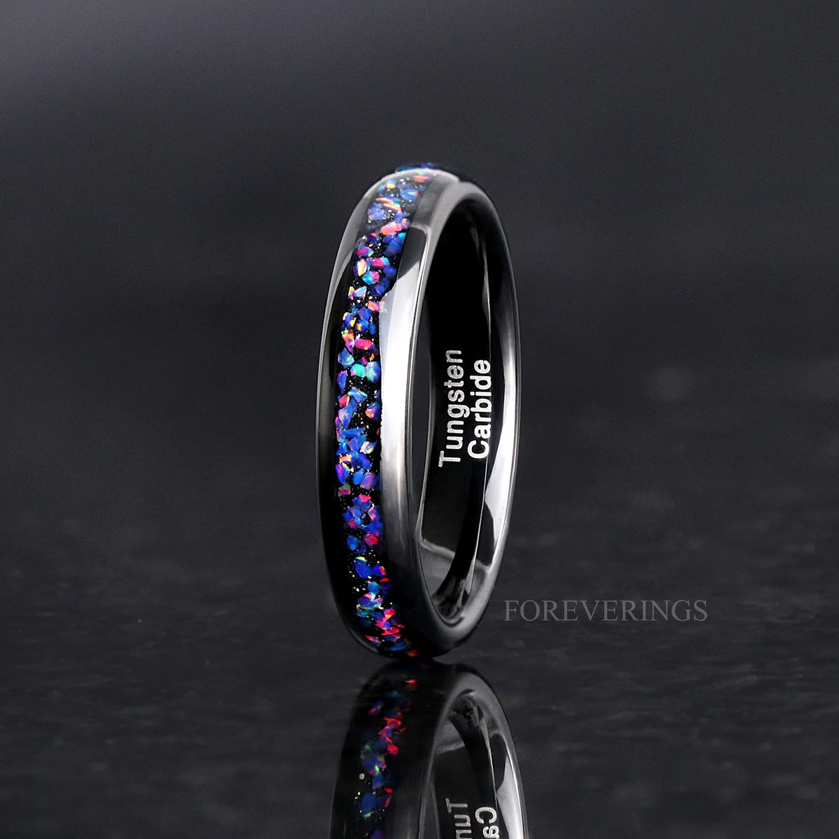 Women's 4mm black tungsten ring with blue opal inlay, standing upright