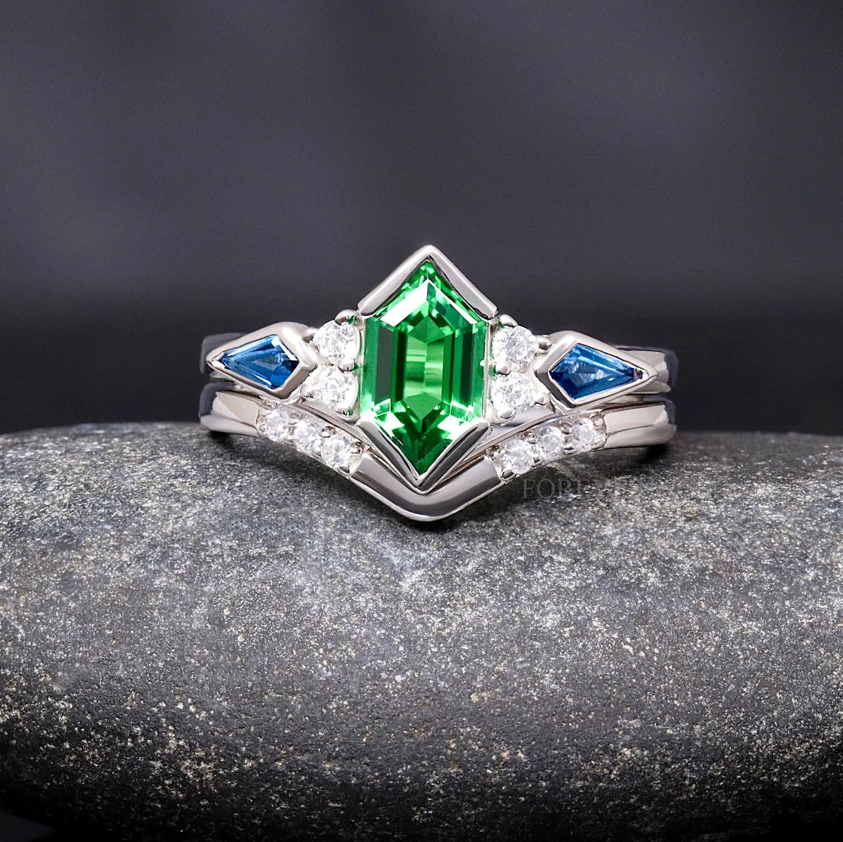 Sterling silver tsavorite engagement ring with sapphire side stones and chevron band, straight on