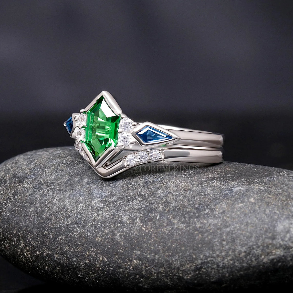 Green tsavorite engagement ring and chevron band in sterling silver, angled side view