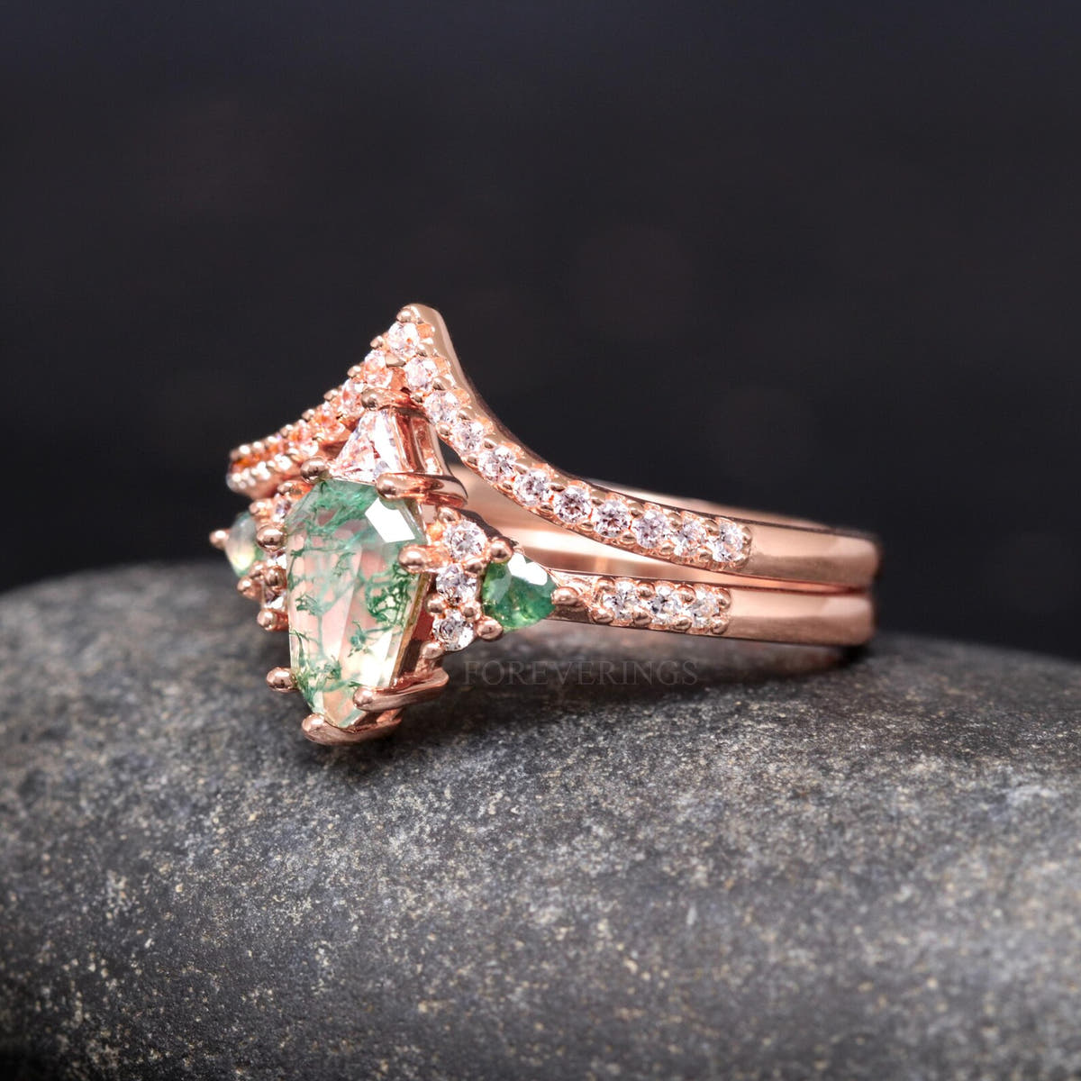 Angled side view of the moss agate bridal set, white stones along the rose gold curved band