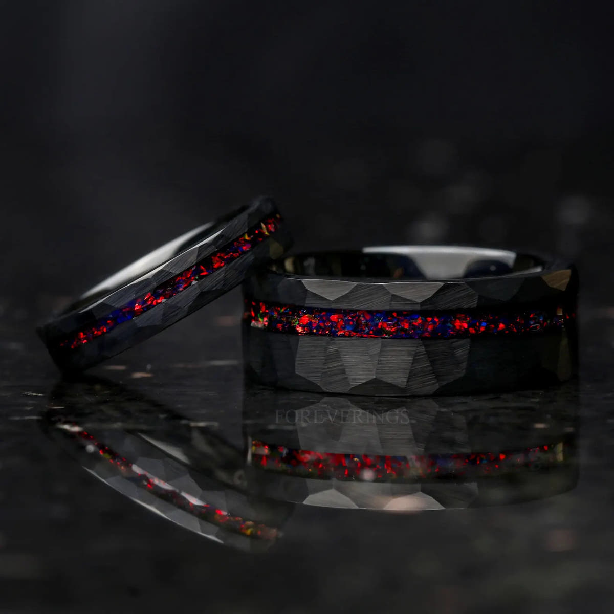 Two widths of the black hammered fire opal band, one leaning on the other