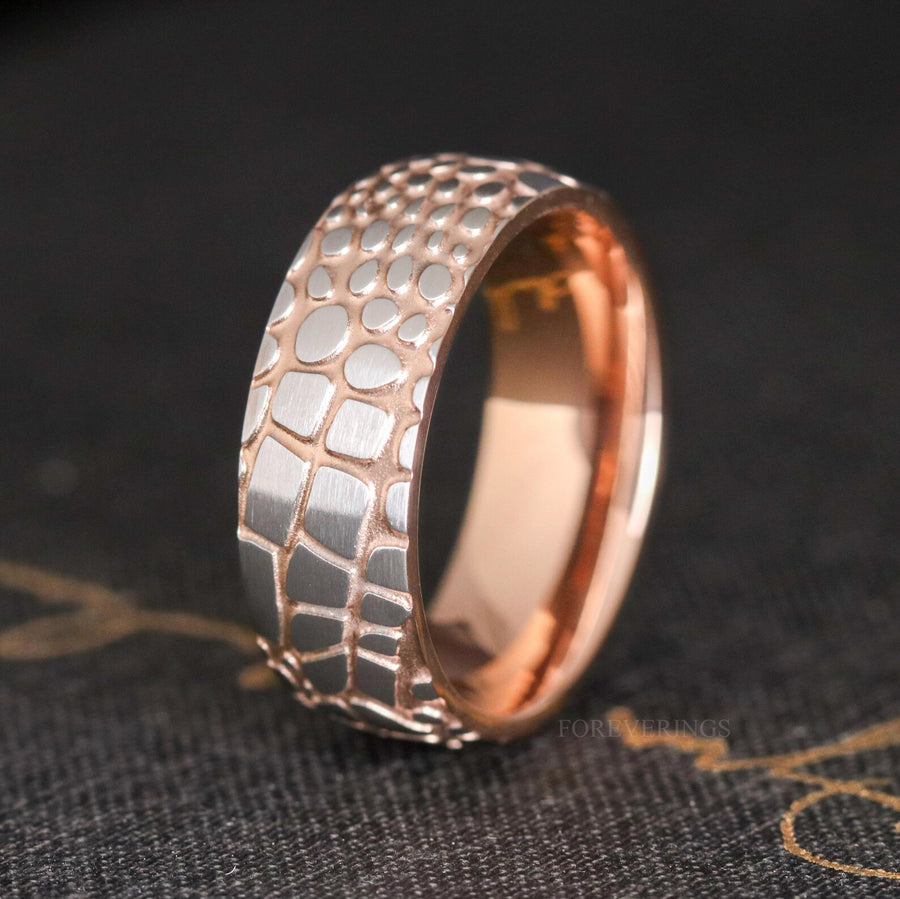 8mm Damascus steel wedding band standing at an angle to show the rose gold interior