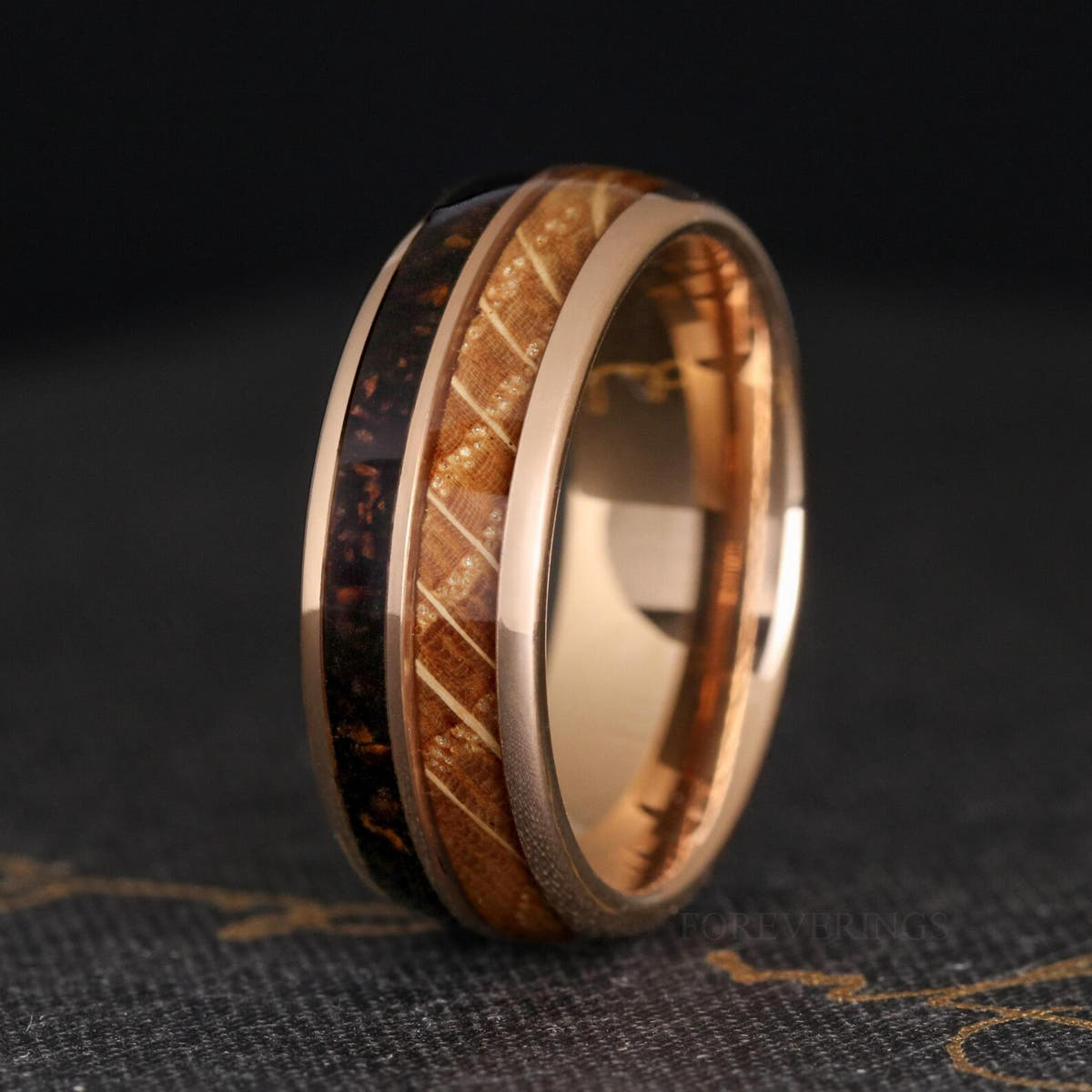 Men's 8mm rose gold tungsten band with whiskey barrel wood and coffee grind inlay, standing upright