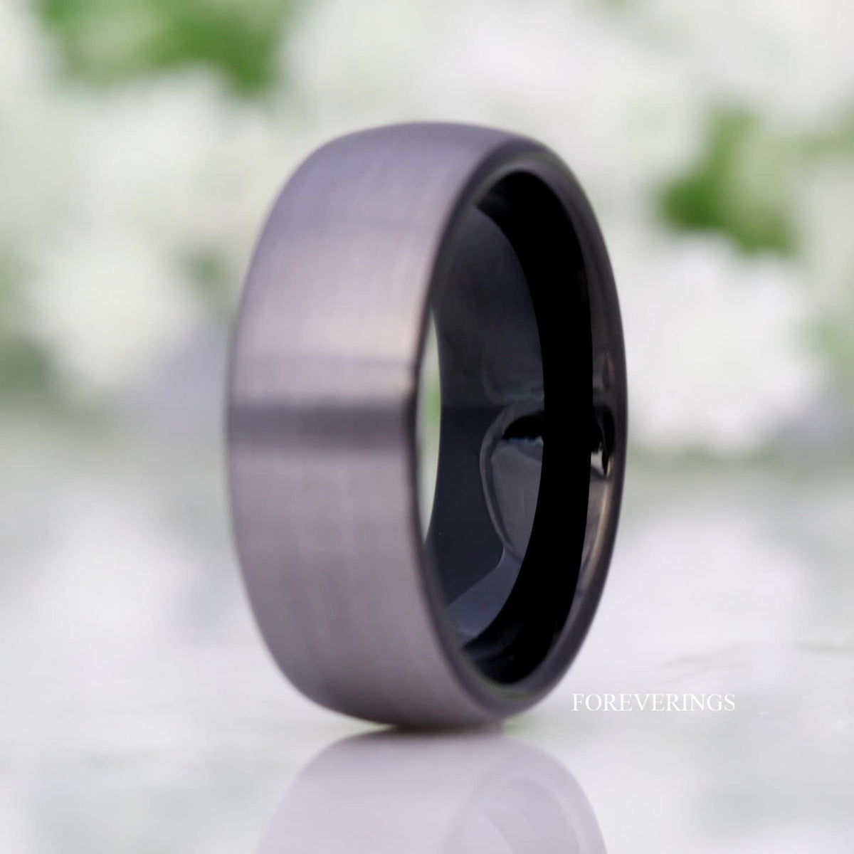 8mm silver and black two-tone tungsten band standing at an angle, wider view