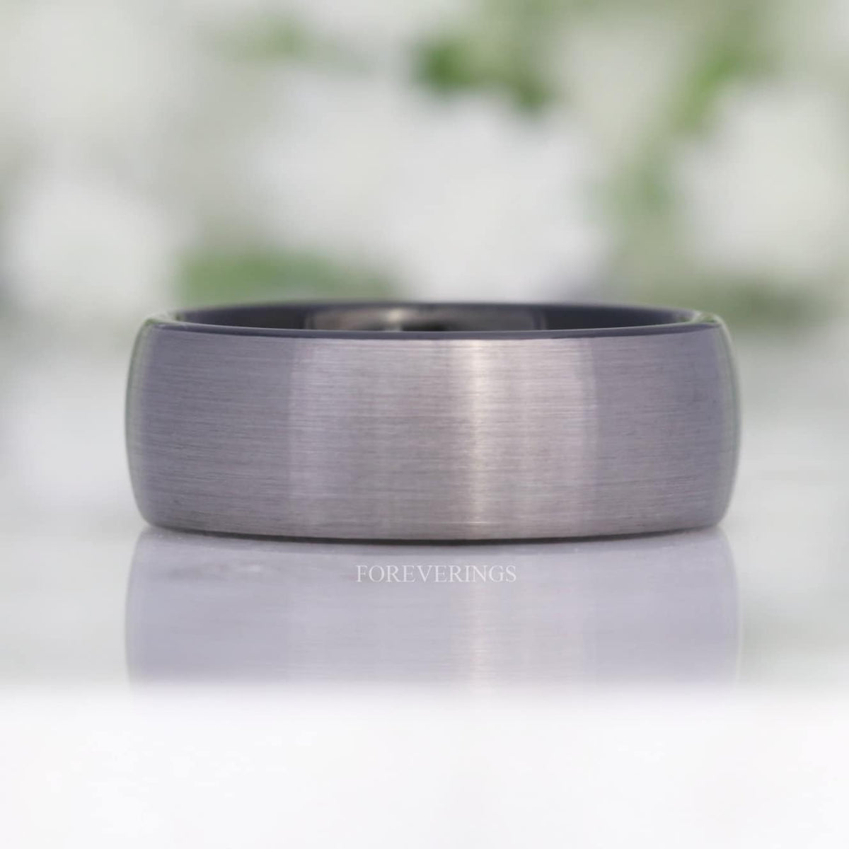 8mm brushed silver tungsten band lying flat, front view with reflection