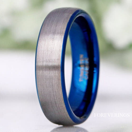Men's 6mm two-tone tungsten wedding band, brushed silver with a blue interior, standing in a close crop