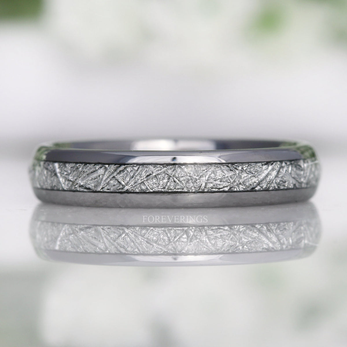4mm silver tungsten band with meteorite-look inlay lying flat, shown straight on