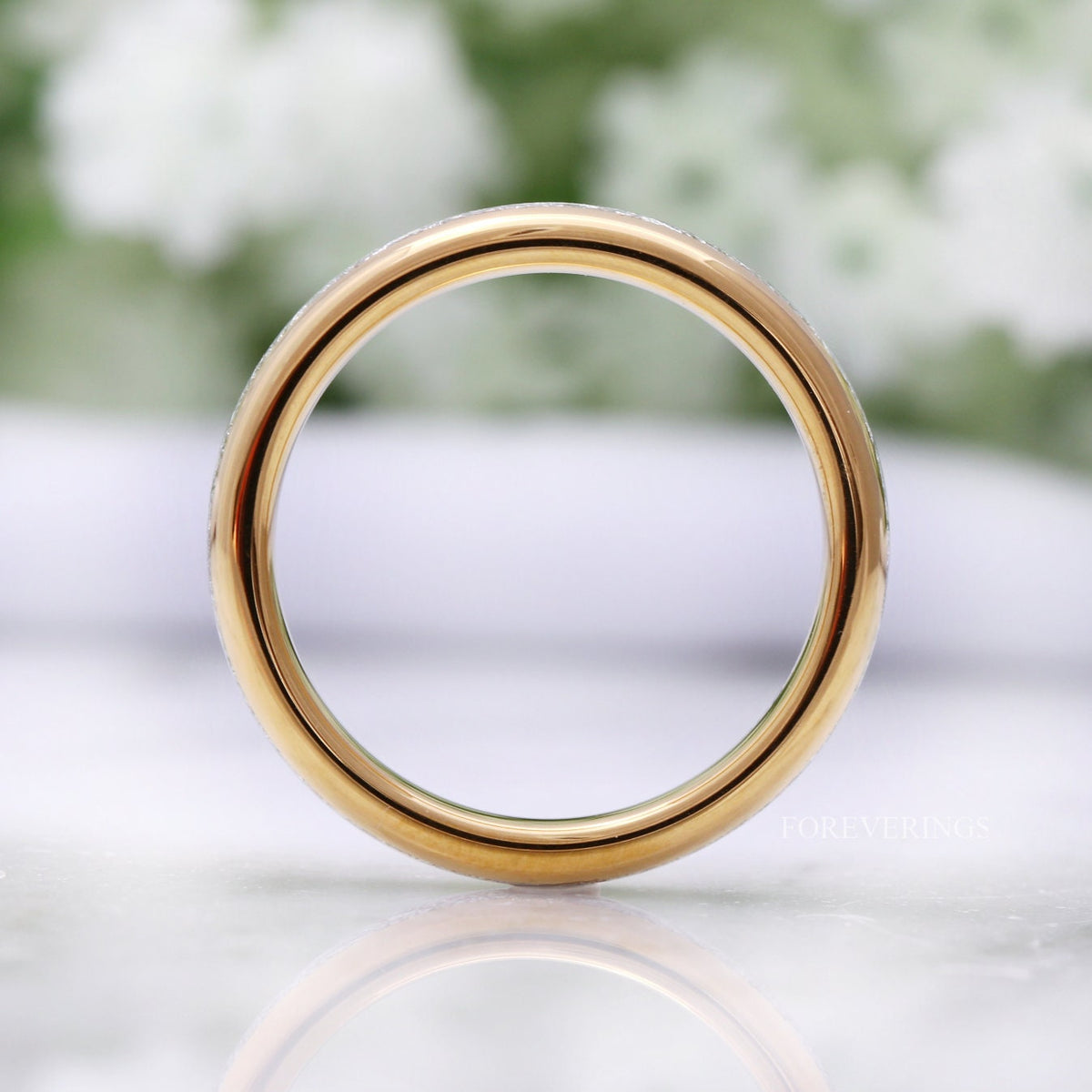 Gold tungsten band viewed straight through the center, polished gold interior
