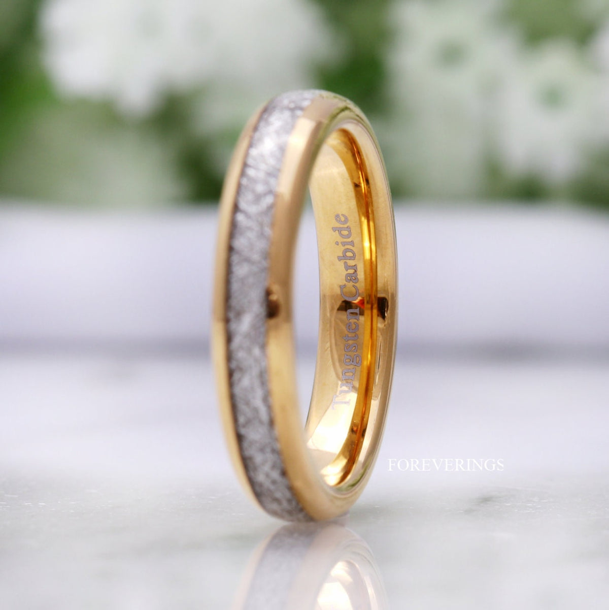 Gold tungsten band with meteorite-look inlay turned to show the polished gold interior