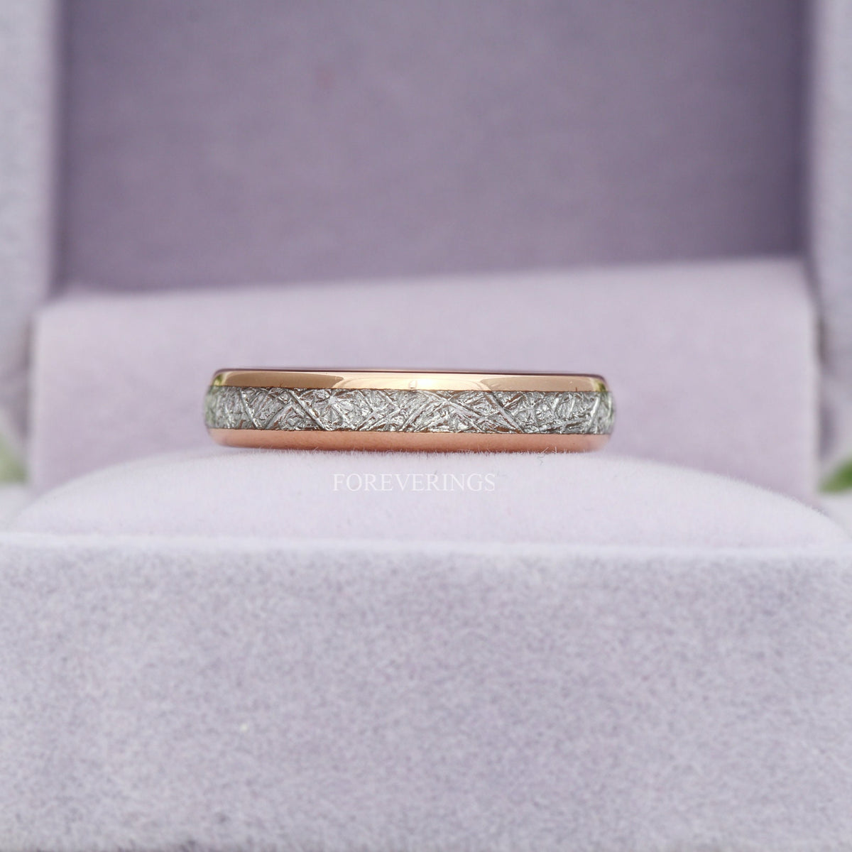 Rose gold tungsten meteorite-look band in a gray velvet ring box